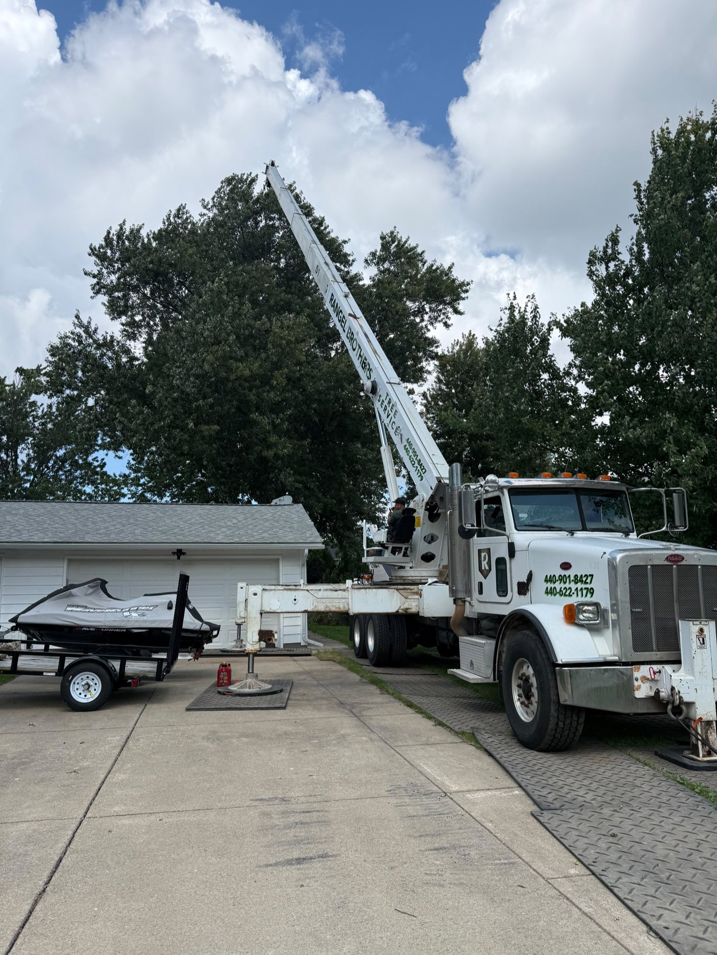 Rangel Brothers crane truck set up on ground protection mats in a driveway Rangel Brothers crane truck set up on ground protection mats in a driveway